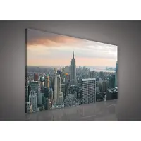 Canvas Schilderij - New York - Stad - Lichten - Skyline - Toren - Blauw - Gebouw - Schilderij Woonkamer - Schilderijen op - Inclusief Frame - 100x75cm (LxB)