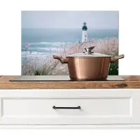 KitchenYeah Spatscherm keuken 60x40 cm - Kookplaat achterwand Vuurtoren - Klif - Zee - Bloemen - Muurbeschermer - Spatwand fornuis - Hoogwaardig aluminium