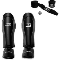 Joya SKINTEX Scheenbeschermers – Kickboksen/Muay Thai/MMA – Zwart/Wit – Maat S – Gegoten model, extra dikke padding – Inclusief Bandage