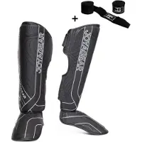 Joya ESSENTIAL Scheenbeschermers – Maat L – Zwart/Wit – Kickboksen/Muay Thai/MMA – Ergonomische pasvorm, schokabsorberende padding – Inclusief Bandage