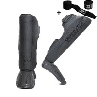 Joya ESSENTIAL Scheenbeschermers – Maat L – Zwart/Zwart – Kickboksen/Muay Thai/MMA – Ergonomische pasvorm, schokabsorberende padding – Inclusief Bandage