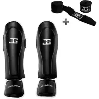 Joya SKINTEX Scheenbeschermers – Kickboksen/Muay Thai/MMA – Zwart/Wit – Maat S – Gegoten model, extra dikke padding – Inclusief Bandage
